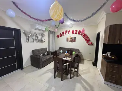 a living room with a happy birthday sign and a table at La Quinta Beach Resort Hurghada in Hurghada