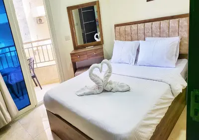 a bedroom with a bed with two towels on it at La Quinta Beach Resort Hurghada in Hurghada