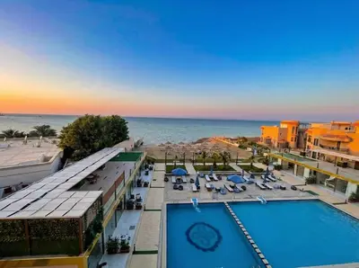 a view of a resort with a swimming pool and the ocean at Seaside studio with private Beach and pool in Hurghada