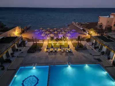 an aerial view of a resort with a pool and the ocean at Seaside studio with private Beach and pool in Hurghada