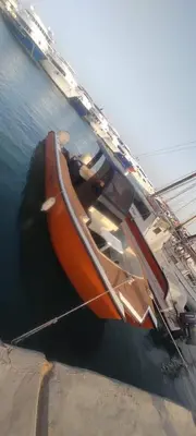 an orange boat is docked in the water at TaiTours in Hurghada