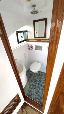 a small bathroom with a toilet and a sink at TaiTours in Hurghada