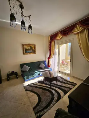 a living room with a couch and a table at Sea-View apartment in El Andalous in Hurghada