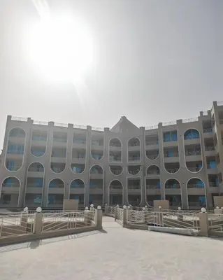 a large building with a lot of windows at Ramses Apartment in Hurghada