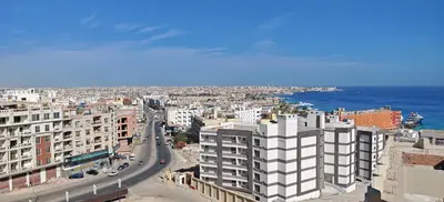 an aerial view of a city with buildings and the ocean at Ramses Apartment in Hurghada