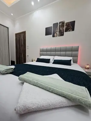 a bedroom with a large bed with a blanket at Ramses Apartment in Hurghada