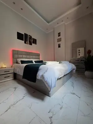 a bedroom with a large bed with a marble floor at Ramses Apartment in Hurghada