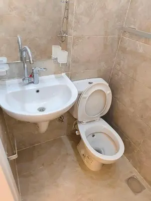 a bathroom with a toilet and a sink at منتجع نوبيا اكوا بيتش in Hurghada