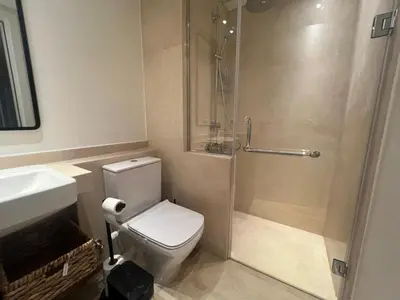 a bathroom with a shower and a toilet and a sink at Ancient Sands 2BR | Ground Floor, Pool Access in Hurghada