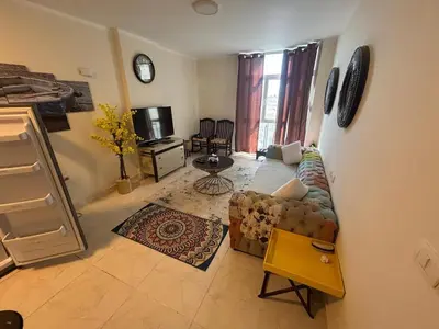 a living room with a couch and a tv at One bedroom apartment in center of the city in Hurghada