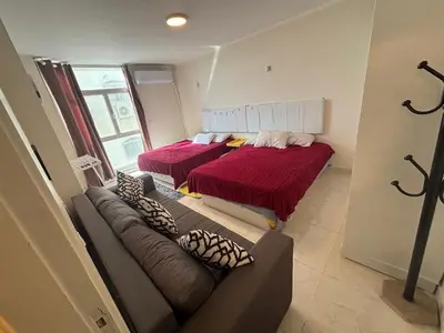 a living room with two beds and a couch at One bedroom apartment in center of the city in Hurghada