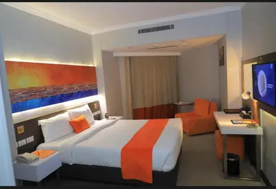a hotel room with a large bed and a television at مول بلازا in Aswān