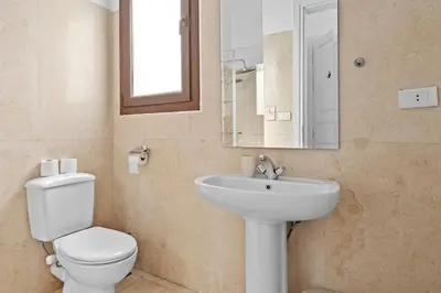 a bathroom with a toilet and a sink and a mirror at South Marina Central 2BR, bathtub, Terraces & Pool in Hurghada