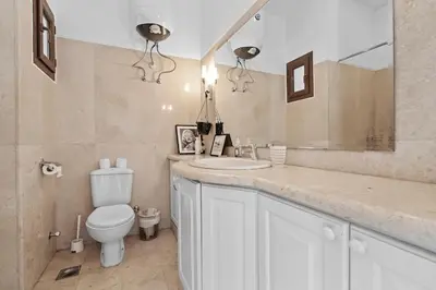 a bathroom with a toilet and a sink and a mirror at South Marina Central 2BR, bathtub, Terraces & Pool in Hurghada