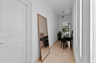 a mirror in a hallway next to a room with a table at South Marina Central 2BR, bathtub, Terraces & Pool in Hurghada