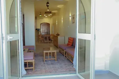 a living room with a glass door and a couch at 36 Southwalk in Quseir