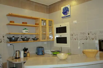 a kitchen with a counter and a clock on the wall at 36 Southwalk in Quseir