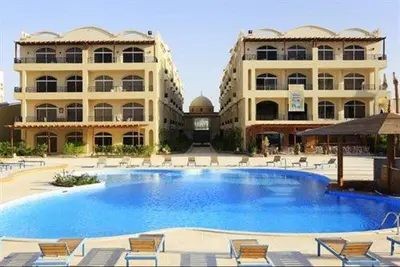 a large pool in front of a large building at Palm Beach Piazza Apart hotel Sahl Hasheesh Hurghada in Hurghada