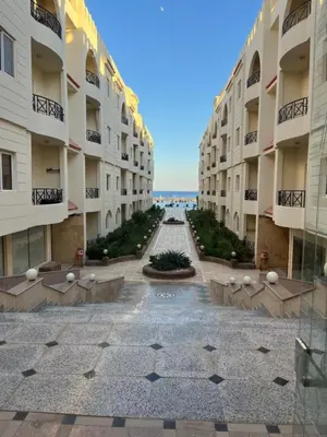 an empty courtyard of a large apartment building at Palm Beach Piazza Apart hotel Sahl Hasheesh Hurghada in Hurghada