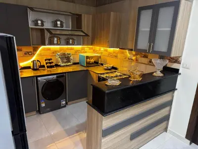 a kitchen with a sink and a stove top oven at Star Luka in Luxor