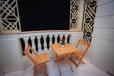 a small table and two chairs on a balcony at Star Luka in Luxor