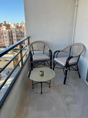 two chairs and a table on a balcony at Tiba golden resort in Hurghada