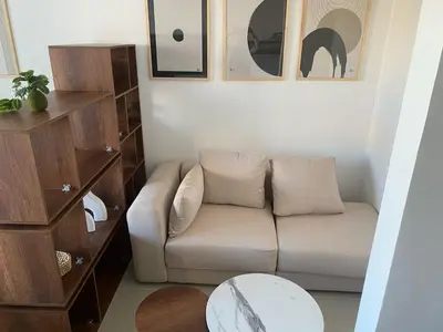 a living room with a couch and a table at Contemporary Condo Studio in G-Cribs in El Gouna
