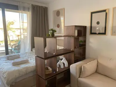 a living room with a bed and a couch at Contemporary Condo Studio in G-Cribs in El Gouna