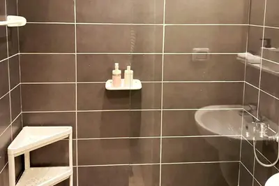 a bathroom with a shower and a sink and a tub at Contemporary Condo Studio in G-Cribs in El Gouna