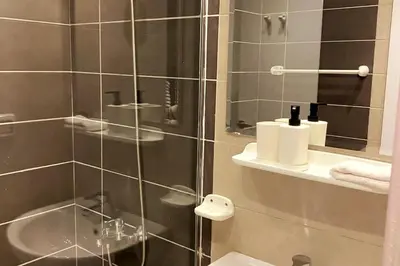 a bathroom with a shower and a toilet and a sink at Contemporary Condo Studio in G-Cribs in El Gouna