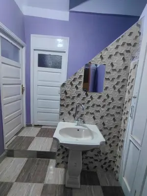 a bathroom with a sink and purple walls at moon guest house in Jazīrat Aswān