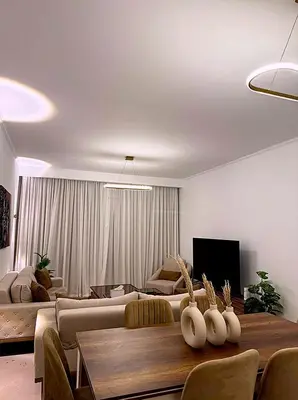 a living room with a couch and a table at Luxury Apartment In Azzurra Sahl Hashish 6G101 in Hurghada