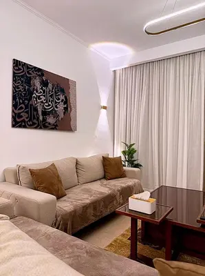 a living room with a couch and a table at Luxury Apartment In Azzurra Sahl Hashish 6G101 in Hurghada
