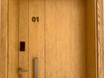 a wooden door with the number o on it at Bright 1BR Apt - Free Beach And Pool In Mangroovy ElGouna in Hurghada
