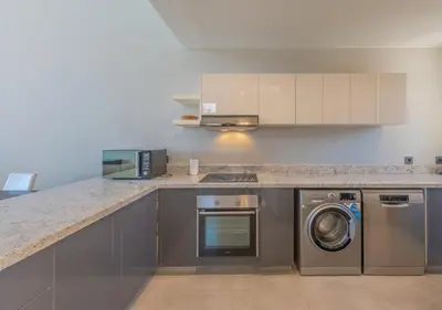 a kitchen with a washer and dryer in it at Ancient Sands 3BR Twin Villa with a Private Patio Heated Swimming Pool & Lagoon Access in Hurghada