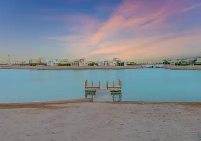 two chairs sitting in the middle of a body of water at Ancient Sands 3BR Twin Villa with a Private Patio Heated Swimming Pool & Lagoon Access in Hurghada