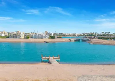 a bench sitting in the middle of a large body of water at Ancient Sands 3BR Twin Villa with a Private Patio Heated Swimming Pool & Lagoon Access in Hurghada