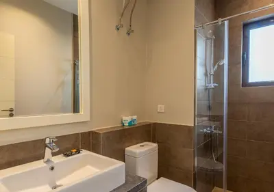 a bathroom with a toilet and a sink and a shower at Ancient Sands 3BR Twin Villa with a Private Patio Heated Swimming Pool & Lagoon Access in Hurghada