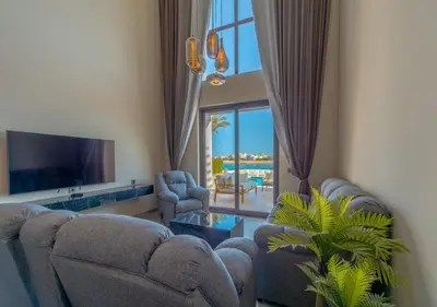 a living room with two couches and a tv at Ancient Sands 3BR Twin Villa with a Private Patio Heated Swimming Pool & Lagoon Access in Hurghada