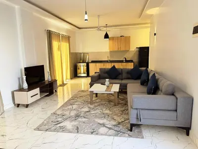 a living room with a couch and a table at Al Baba II Nile Villa in Luxor