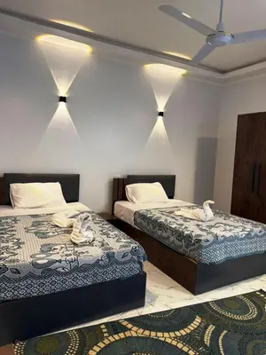 two beds in a room with lights on the wall at Al Baba II Nile Villa in Luxor