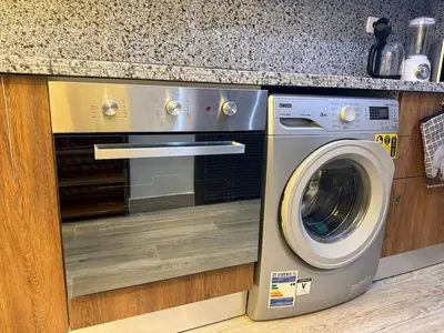 a washer and dryer under a counter in a kitchen at Private Rooftop Two Bedroom SeaView Panorama in Hurghada
