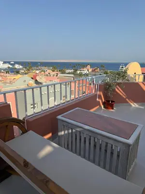 a balcony with a table and a view of the ocean at Private Rooftop Two Bedroom SeaView Panorama in Hurghada