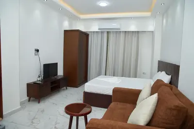a hotel room with a bed and a couch at Juliana beach resort by V in Hurghada