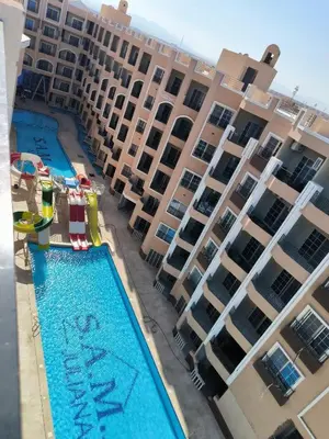 an aerial view of a large apartment building with a swimming pool at Juliana beach resort by V in Hurghada