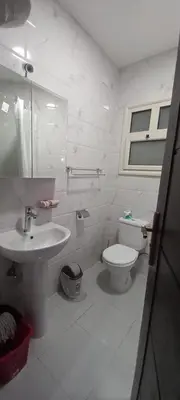 a white bathroom with a sink and a toilet at Sea view studio for rent at Juliana at Hurghada in Hurghada