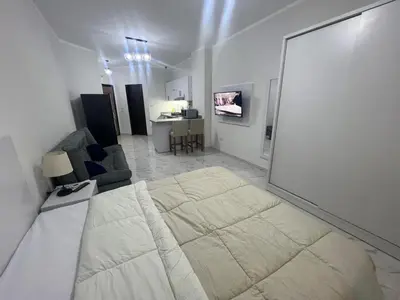a white room with a bed and a couch at Sea view studio for rent at Juliana at Hurghada in Hurghada
