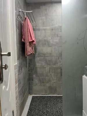 a bathroom with a shower with gray tiles at Hurghada scandic resort in Hurghada