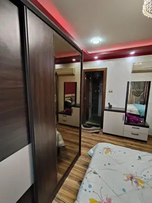 a room with a bed and a mirror at شقة بمول اسوان بلازا- اسوان in Aswān