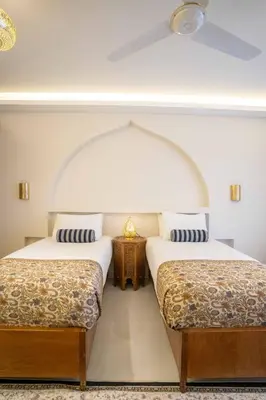 two beds sitting next to each other in a room at Theban Hills Hotel, Luxor in ‘Ezbet Abu Ḥabashi